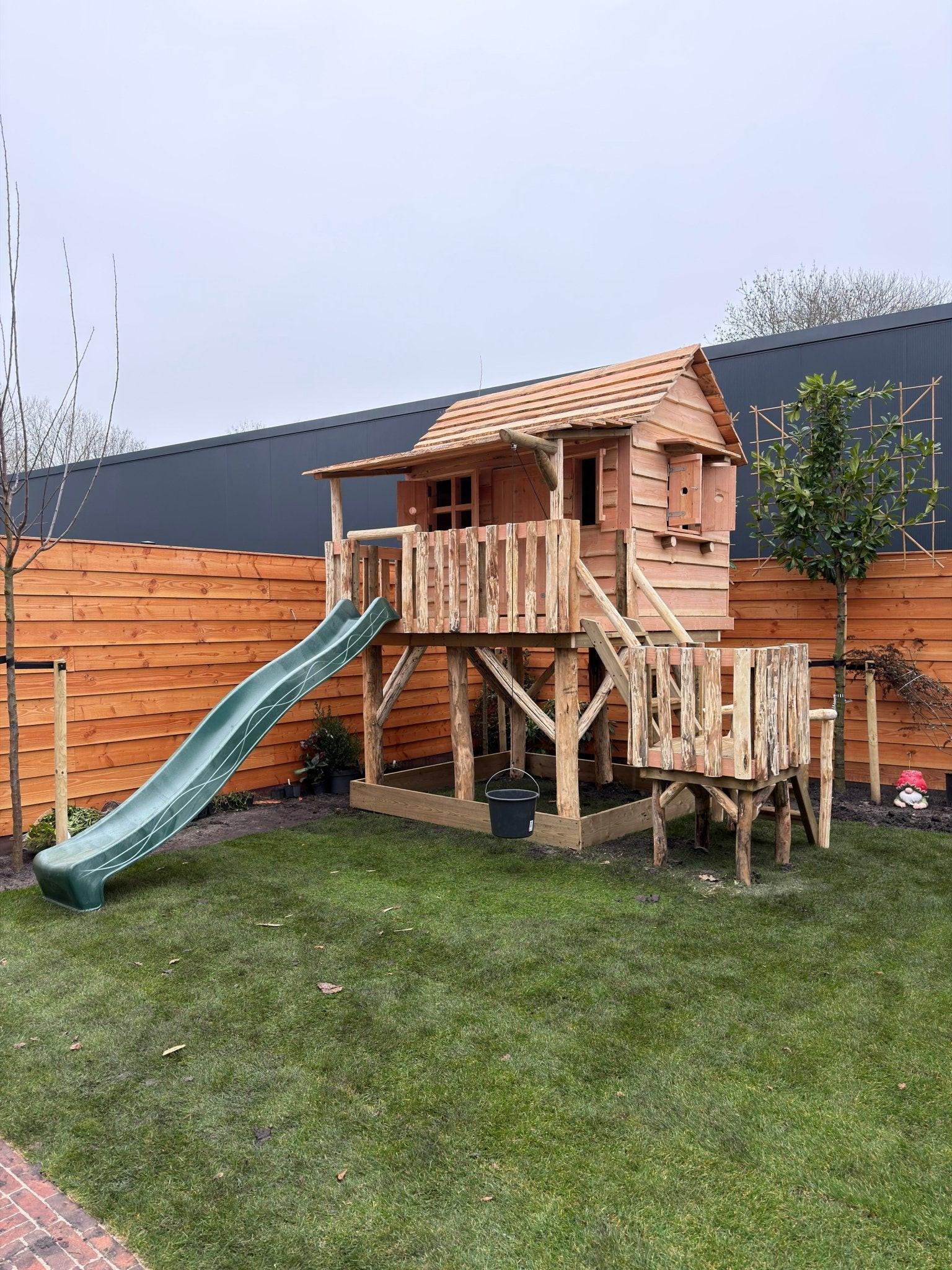 Zandbak onder speelhuisje (geïmpregneerde steigerplanken)Zandbakken speelhuisje buiten.